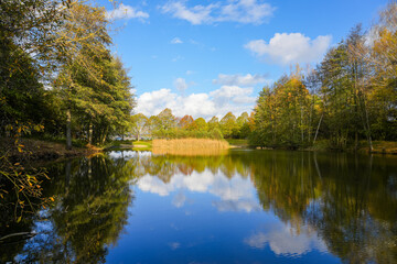 Ostheim natural bathing lake near Malsfeld. Idyllic landscape by the lake in autumn. 
