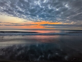 Fototapeta na wymiar Cloud reflection Druridge Bay Northumberland UK
