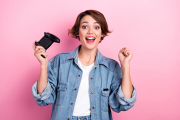 Photo of funky funny lady dressed denim jacket rising fist playing video game isolated pink color background © deagreez