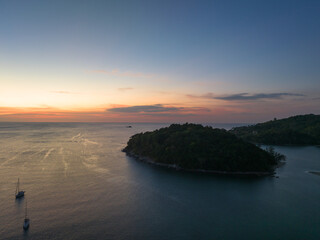 Fototapeta premium .aerial view beautiful sunset above Kala island at Layan beach Phuket..colorful sky of sunset at horizon.Phuket beach sea Amazing beach, .Beautiful beach Phuket Thailand, Nature and travel concept.
