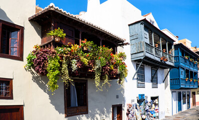Fototapeta na wymiar Close up of Traditional colonil hoses with wood balcony decorated with flowers in Santa Cruz de La Palma, Canary island, Spain