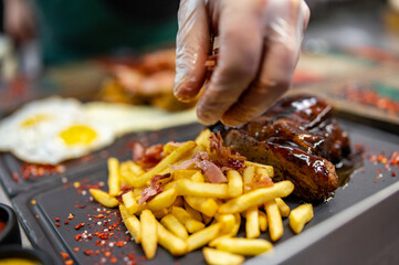 chef cooking meat rib in the kitchen restaurant