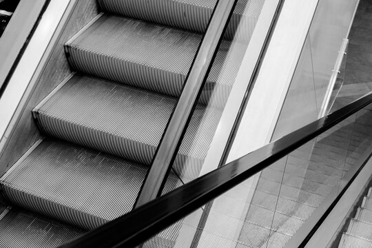 Escalator in the shopping center. Black and white photo.