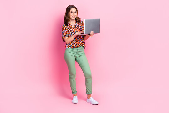 Full body size cadre of youngster pretty it worker woman python development programmer hold netbook online chat isolated on pink color background