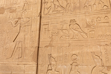 Fototapeta na wymiar Edfu Horus Temple Walls Decorated with Reliefs of Ancient Egyptian Gods. Ptolemaic Temple of Horus, Edfu near Aswan, Egypt. Africa.