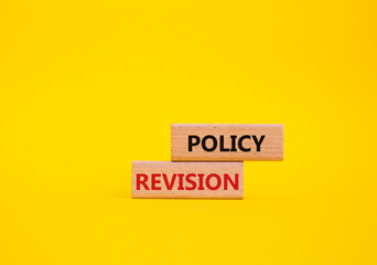 Policy revision symbol. Concept word Policy revision on wooden blocks. Beautiful yellow background. Business and Policy revision concept. Copy space