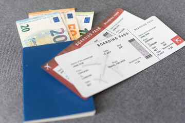 Two tickets for plane with passports on gray background