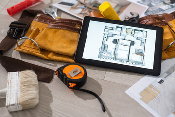 Computer Tablet Showing apartment Illustration Sitting On House Plans. tools