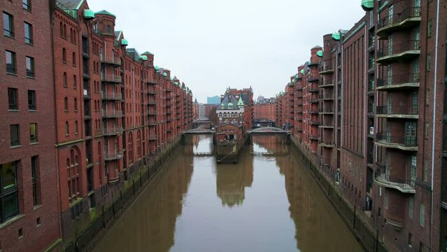 Aerial drone view of Speicherstadt in Hamburg, Germany. Residential district with classic buildings and water channels. Cloudy weather