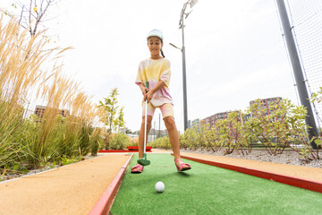 cute little girl on a miniature golf course