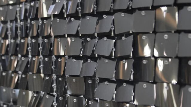 wall with sequins. iridescent and shiny plates as a decor. 