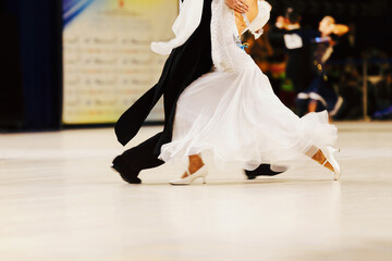 couple dancers man in black tailcoat and woman in white ball gown