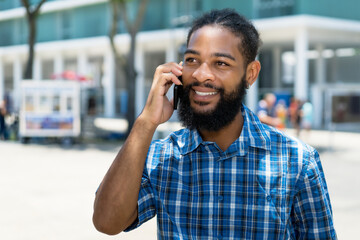 Laughing black man with beard  talking with girlfriend at phone