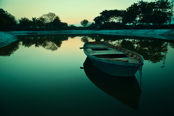 row wooden boat with reflection . desktop background and wallpapers.