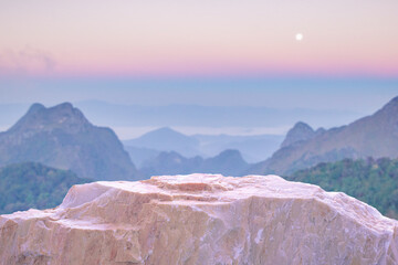 Stone podium table top with outdoor mountains pastel color scene nature landscape at sunrise blur...