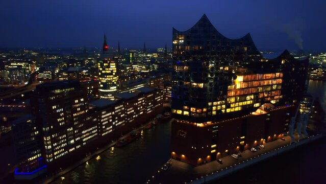 Aerial drone view of Speicherstadt in Hamburg at evening, Germany. Residential district with classic and modern buildings, water channels, Elbe river