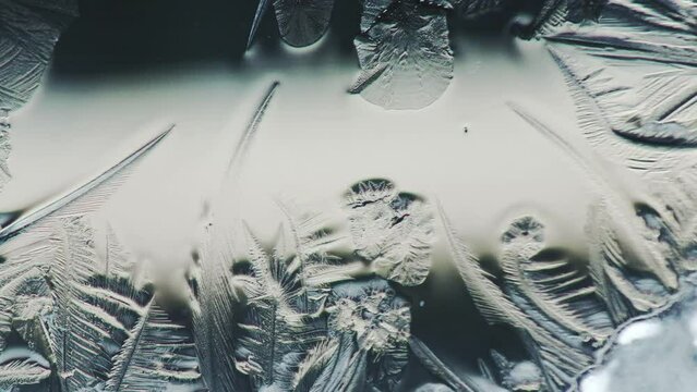 Science project. Ice covers smooth water surfaces. Crystallization of water. Icing