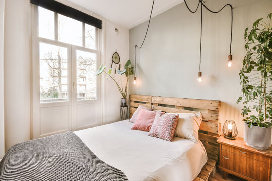 Stylish bedroom with wooden bed