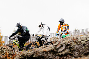 downhill group riders. start of race autumn mountain trail