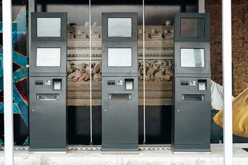 Several self service payment terminals in the street