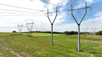 Electric power towers with blue sky and green countryside in America's heartland
