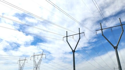 Electric power towers with blue sky and green countryside in America's heartland