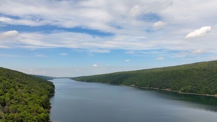 Hemlock Lake New York Finger Lake with blue sky and clouds and green mountains in Natural area