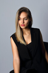 Portrait of a young woman in black in the studio