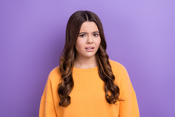 Photo of nervous lady girl wear orange trendy clothes suspicious look camera disagree social opinion isolated on purple color background