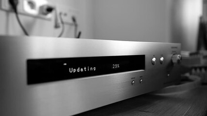 Black and white image - update percentage bar dot matrix display message on new HI-FI network audio player with Hi-Res Audio during first setup wi-fi message firmware percentage