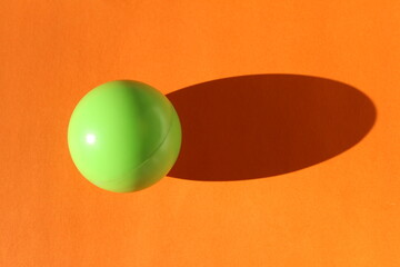 Green ball on orange background