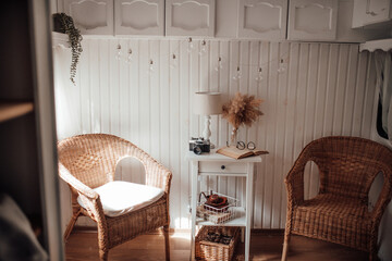 Details wooden interior of retro travel trailer in neutrals tones colors at natural lighting
