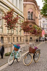 Two beautiful bicycles on the street.Bicycle with flowers on a street.