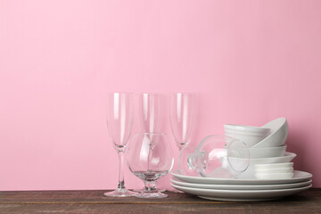 many different dishes. Dinnerware. on a pink background. utensils for table setting. various plates, bowls and cups.