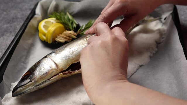 The chef stuffs the fish in salt with spices before baking. The process of cooking fish in a salt shell flamb&eacute; in the oven. Shooting from above