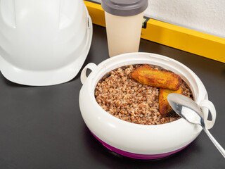 Thermos for food on the table. Lunch break. Close-up