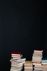 many books large stacks on the table in the library on a black background