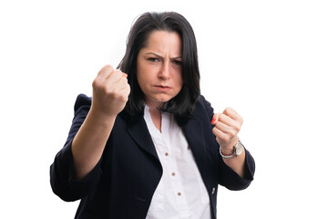 Angry businesswoman showing fists as aggressive concept
