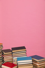 many books stacked in the library on a pink background science knowledge reading