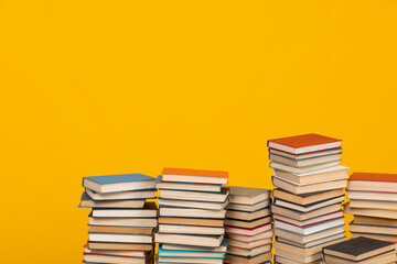 many books stacked in the library on a yellow background science knowledge reading