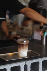 Closeup of Iced Caramel Macchiato at the coffee shop, Caramel Macchiato is a classic macchiato beverage. It consists of vanilla syrup, espresso, steamed milk, foam, and caramel drizzle