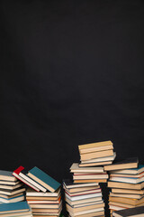 science knowledge reading many books in stacks in the library on a black background