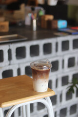 Closeup of Iced Caramel Macchiato at the coffee shop, Caramel Macchiato is a classic macchiato beverage. It consists of vanilla syrup, espresso, steamed milk, foam, and caramel drizzle