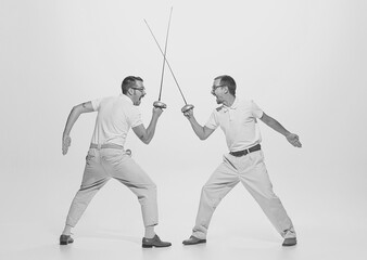 Black and white portrait of two retro men fence with exressive facial expressions. Vitage, retro...