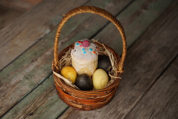 Easter basket on a wooden background.