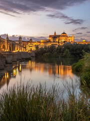 Night Exposure of the Roman bridge of and the Mosque–Cathedral of Córdoba in the background with the Guadalquivir river in the foreground