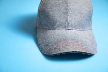 Baseball cap on the blue background.