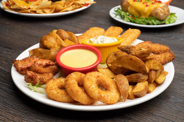 Combo plate of Cheese balls, Mozzarella cheese, Wedges, Garlic Bread, Chicken Tenders with sauce
