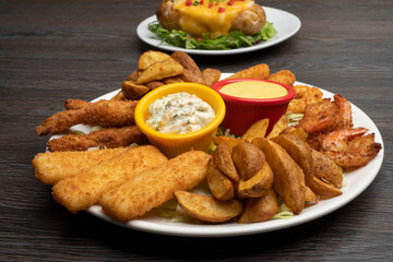 Combo plate of Cheese balls, Mozzarella cheese, Wedges, Garlic Bread, Chicken Tenders with sauce