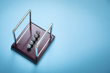 Newton's cradle balls on the blue background.